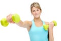 Getting shape for a healthier lifestyle. Sporty young woman lifting dumbbells while isolated on white. Royalty Free Stock Photo