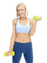 Getting shape makes her feel great. Sporty young woman lifting dumbbells while isolated on white.