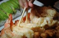 Getting shrimp tempura using chopstick Royalty Free Stock Photo