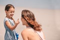 Getting silly with the sunscreeen. a little girl applying suntan lotion to her mothers face at the beach. Royalty Free Stock Photo