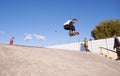 Getting some air. A young man doing tricks on his skateboard at the skate park. Royalty Free Stock Photo