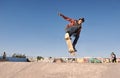 Getting some air. A young man doing tricks on his skateboard at the skate park. Royalty Free Stock Photo