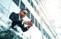 Getting some fresh air. Low angle shot of a handsome mature businessman making a phonecall while standing on his office Royalty Free Stock Photo