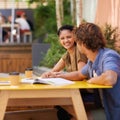 Getting in some studies between classes. A shot of university students enjoying their outdoor study session. Royalty Free Stock Photo