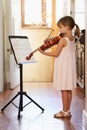 Getting in some violin practive. a young girl playing violin.