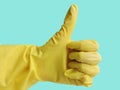 Getting started cleaning. Yellow rubber gloves for cleaning on blue background