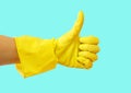 Getting started cleaning. Yellow rubber gloves for cleaning on blue background .General or regular cleanup.