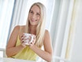Getting started with a cup of java. an attractive young woman drinking a coffee at home. Royalty Free Stock Photo