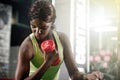 Getting stronger with every lift. a young woman lifting weights at the gym.