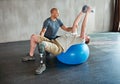 Getting stronger one session at a time. Studio shot of a young amputee training in a gym.