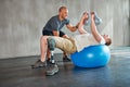 Getting stronger. Studio shot of a young amputee training in a gym.