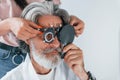 Getting tested by woman worker. Senior man with grey hair and beard is in ophthalmology clinic Royalty Free Stock Photo