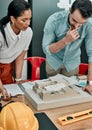 Getting their creative juices flowing. two architects working together on a scale model of a building in an office. Royalty Free Stock Photo