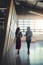 Getting their facts together before entering the meeting. two businesswomen having a discussion while walking through a Royalty Free Stock Photo