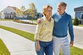 Getting to know their new neighborhood together. a happy senior couple waking around their neighborhood together.