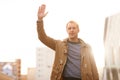 Getting to work the easy way. a casually dressed man hailing a cab in the city. Royalty Free Stock Photo