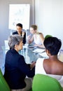 Getting together to brainstorm. a group of coworkers having a meeting in the boardroom.