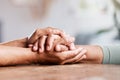 Getting through the tough stuff, together. an unrecognizable senior couple holding hands and comforting one another at Royalty Free Stock Photo