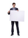 Getting your attention with a large sign. A handsome young businessman holding a large placard. Royalty Free Stock Photo