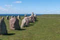 Tourists explore Gettlinge grave field with its famous stone ship in Gettlinge. The oldest graves date back to the Nordic bronze Royalty Free Stock Photo