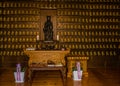 Sitting wooden Buddha in temple prayer hall