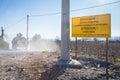 Macedonian army tank passing in front of a roadsign indicating the border with Eidomeni/Idomeni in Greece is closed