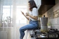 geyser coffee kettle on the cook top at the kitchen woman drinking on background