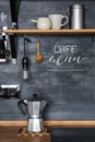 Geyser coffee maker on the background of a dark chalky kitchen wall in a loft-rustic style