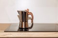 Geyser coffee maker on electric cookstove, kitchen interior. Selective focus Royalty Free Stock Photo