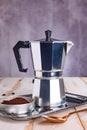 Geyser coffee maker stands on a white kitchen table. Everything is ready for the preparation of a fragrant drink