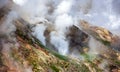 Geyser landscape with emissions of steam, gases and hot water in the country of volcanoes on the Kamchatka Peninsula