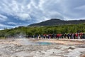 Strokkur geyser just before erupting and many tourists waiting