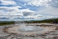 Strokkur geyser just before erupting and many tourists waiting