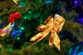 Ggolden bow on an artificial Christmas tree close Royalty Free Stock Photo