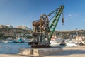 Ghajnsielem, Malta - May 8, 2017: Mgarr Harbour promande with historic crane at Gozo island.