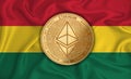 Ghana flag ethereum gold coin on flag background. The concept of blockchain bitcoin currency decentralization in the country.