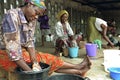 Ghanaian women in colorful clothing washing laundry