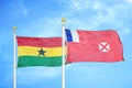 Ghana and Wallis and Futuna two flags on flagpoles and blue sky