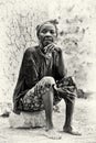 A Ghanaian lady sits on the stone