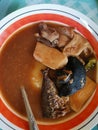 Ghanaian local food. Fufu with light soup. Snail, mushrooms, fish