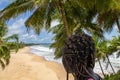 Ghanaian woman looks out over the coast of Axim