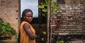 A Ghanaian woman stands at the doorway