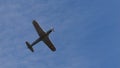 Retro propeller training airplane of 1940s in flight in blue sky. Copy space