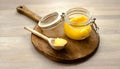 Ghee clarified butter desi in glass jar with spoon made from wood on natural wooden background Royalty Free Stock Photo