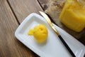 Ghee on a white plate, close-up. A healthy high fat dairy product.