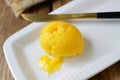 Ghee on a white plate, close-up. A healthy high fat dairy product.