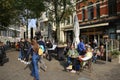 View on market square with people sitting exterior of cafe restaurant on sunny day