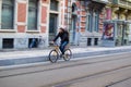 Ghent, Belgium; 10/31/2018: Panning effect photography of a man riding on a bike through a street in the city