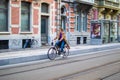 Ghent, Belgium; 10/31/2018: Panning effect photography of a woman riding on a bike through a street in the city