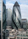 Gherkin Building, 30 St Mary Axe in the City of London financial district, with reflection in adjacent building, London UK Royalty Free Stock Photo